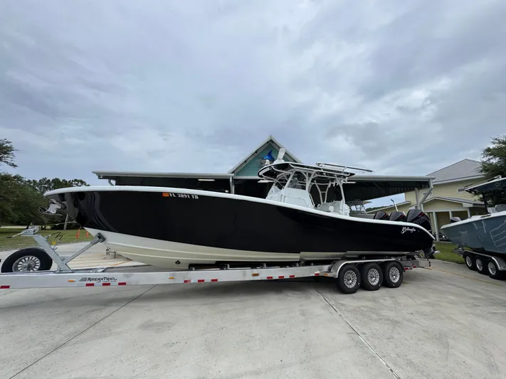  Yacht Photos Pics 2021 Yellowfin 36 Offshore boat on trailer, parked outdoors under cloudy sky.