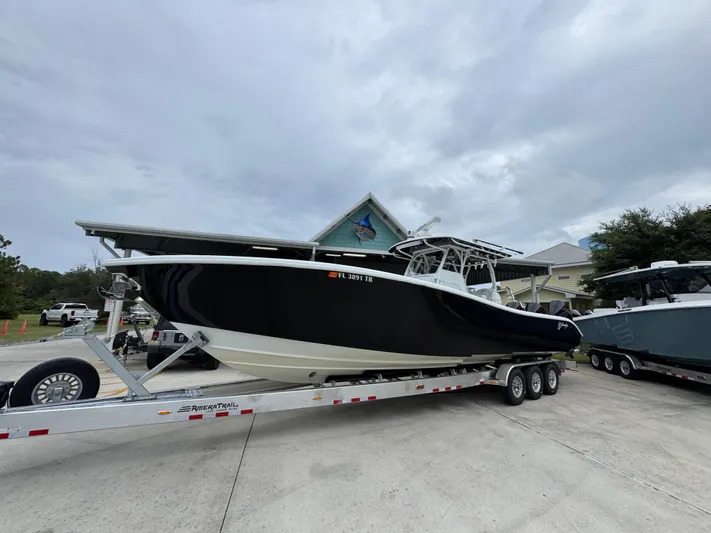  Yacht Photos Pics 2021 Yellowfin 36 Offshore boat on trailer, parked outdoors.