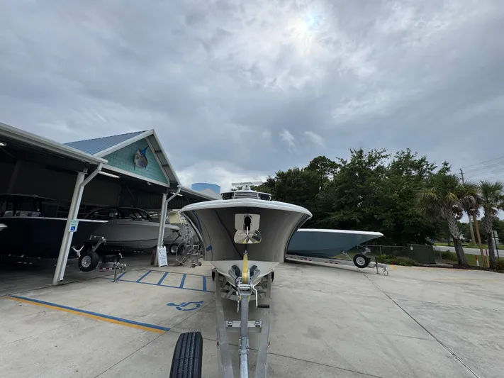  Yacht Photos Pics 2021 Yellowfin 36 Offshore boat on trailer at marina under cloudy sky.
