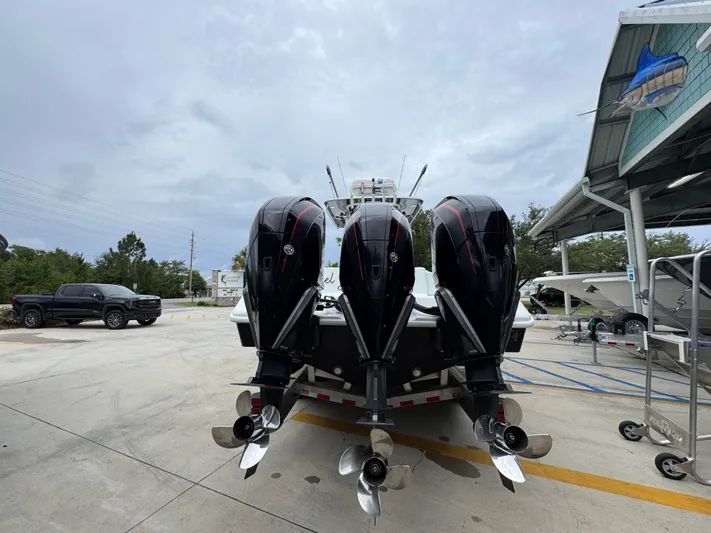  Yacht Photos Pics 2021 Yellowfin 36 Offshore boat with triple outboard engines in a marina setting.