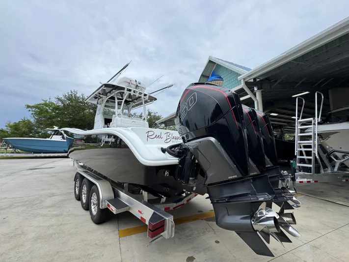  Yacht Photos Pics 2021 Yellowfin 36 Offshore boat with triple outboard engines on a trailer.
