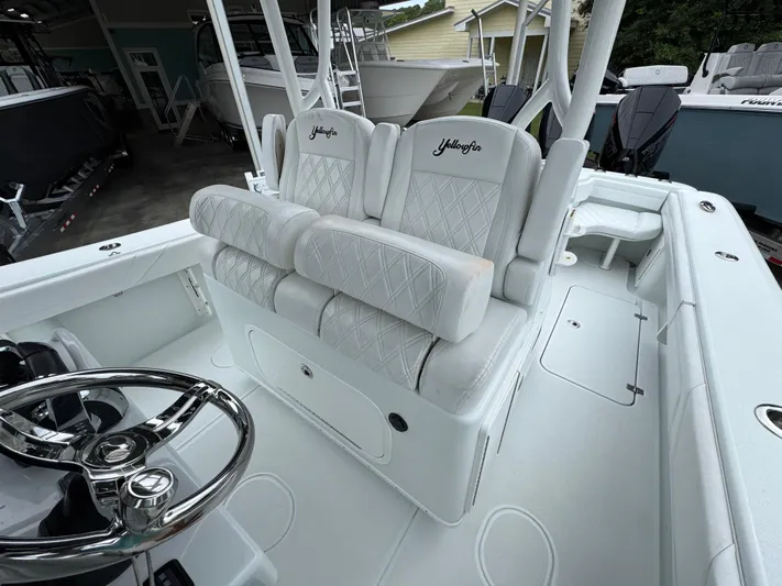  Yacht Photos Pics 2021 Yellowfin 36 Offshore boat interior with white seating and steering wheel.
