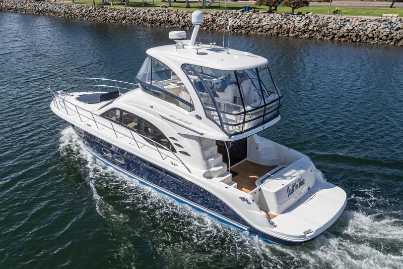  Yacht Photos Pics 2005 Sea Ray 500 Sedan Bridge yacht cruising on a calm waterway.