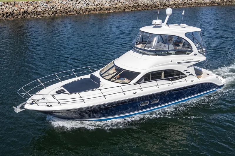  Yacht Photos Pics 2005 Sea Ray 500 Sedan Bridge yacht cruising on water, showcasing sleek design and luxury features.
