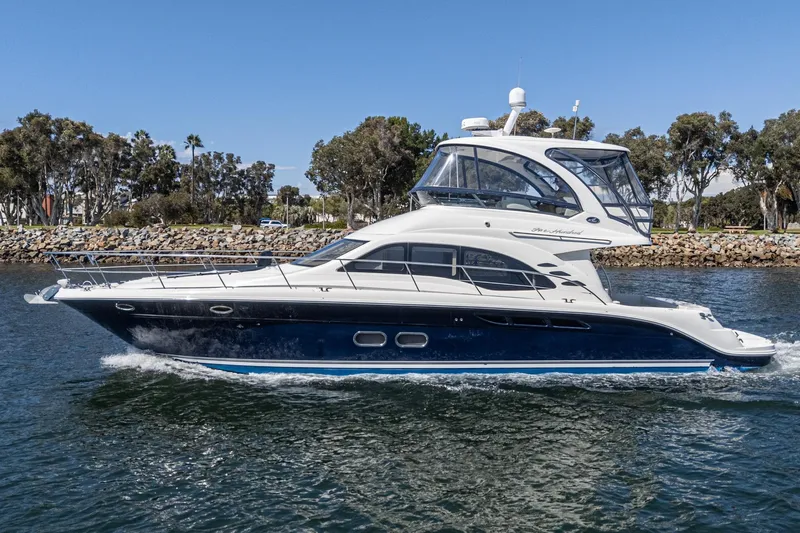  Yacht Photos Pics 2005 Sea Ray 500 Sedan Bridge yacht cruising on a calm waterway.
