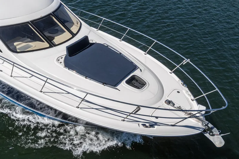  Yacht Photos Pics 2005 Sea Ray 500 Sedan Bridge yacht cruising on open water.