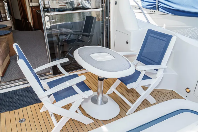  Yacht Photos Pics 2005 Sea Ray 500 Sedan Bridge yacht deck with chairs and table.