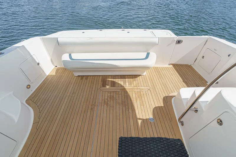  Yacht Photos Pics 2005 Sea Ray 500 Sedan Bridge boat deck with teak flooring and seating, overlooking water.