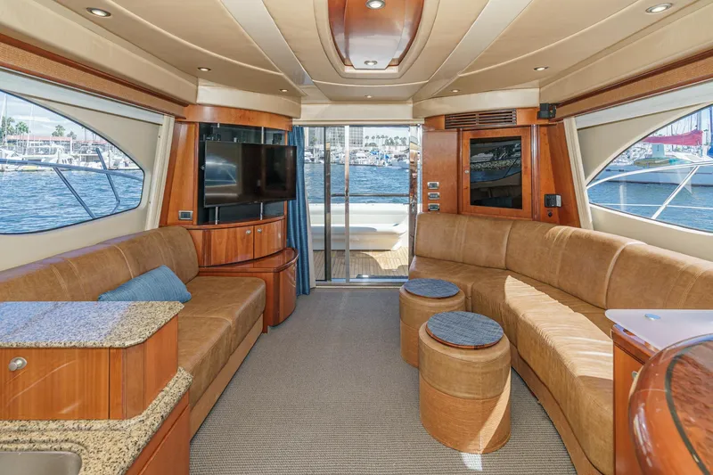  Yacht Photos Pics Luxurious interior of 2005 Sea Ray 500 Sedan Bridge yacht with plush seating and waterfront view.