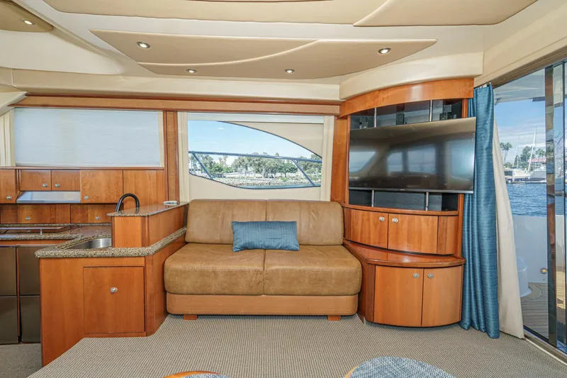  Yacht Photos Pics Luxurious interior of 2005 Sea Ray 500 Sedan Bridge yacht with sofa and TV.