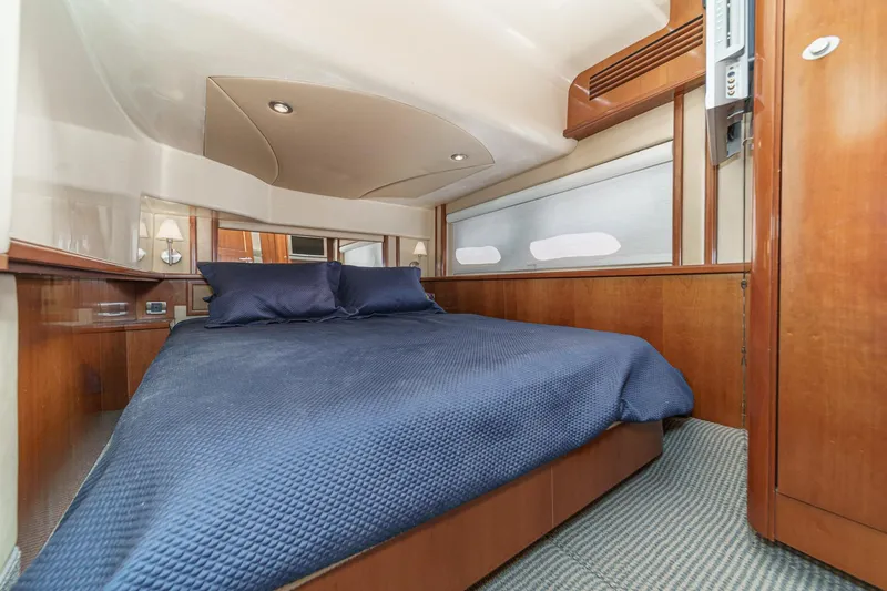  Yacht Photos Pics Luxurious cabin interior of 2005 Sea Ray 500 Sedan Bridge yacht with blue bedding.