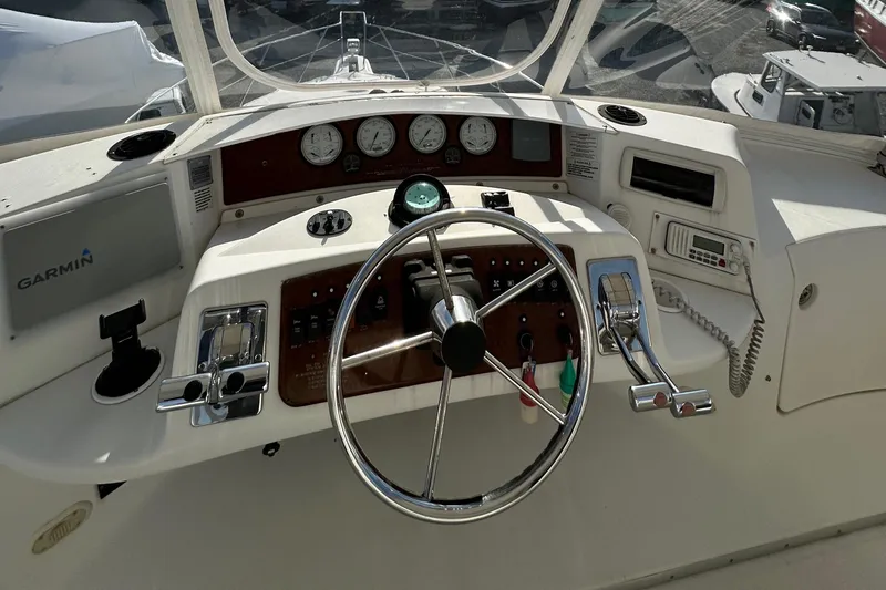 "fish N Chicks" Yacht Photos Pics 2005 Silverton 34 Convertible boat helm with steering wheel and navigation instruments.