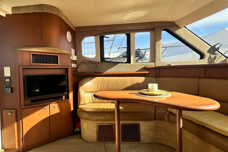 "fish N Chicks" Yacht Photos Pics Interior of 2005 Silverton 34 Convertible yacht with cozy seating and TV.