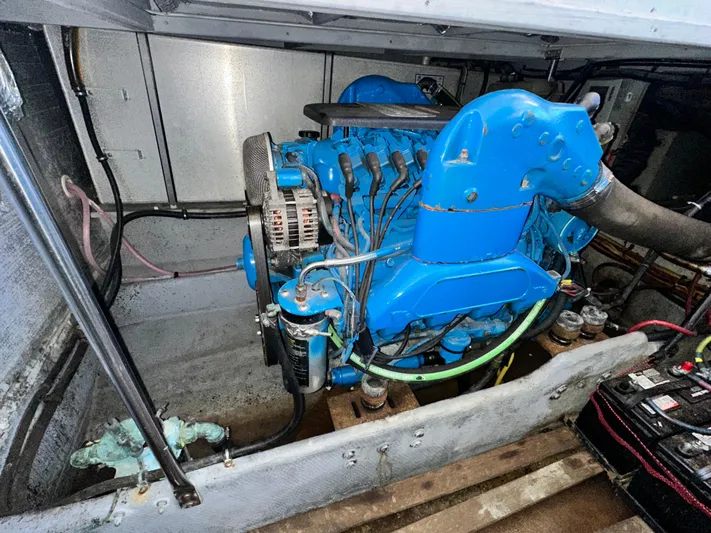 "fish N Chicks" Yacht Photos Pics Engine compartment of a 2005 Silverton 34 Convertible boat, featuring a blue engine.