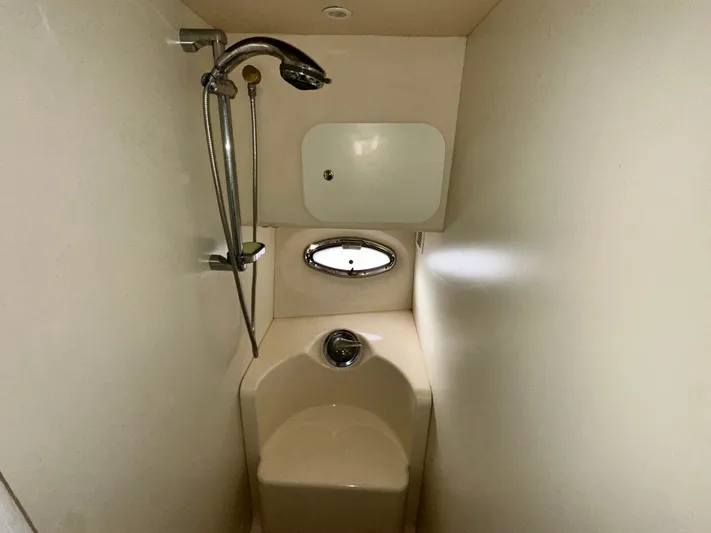 "fish N Chicks" Yacht Photos Pics 2005 Silverton 34 Convertible yacht bathroom with shower and porthole window.