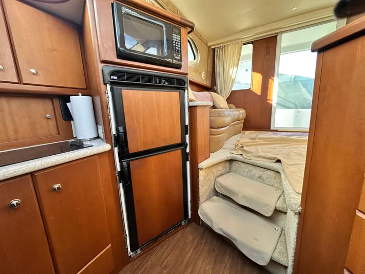 "fish N Chicks" Yacht Photos Pics Interior of 2005 Silverton 34 Convertible yacht with kitchen and stairs.