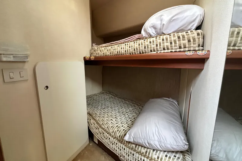 "fish N Chicks" Yacht Photos Pics 2005 Silverton 34 Convertible yacht interior with cozy bunk beds and pillows.