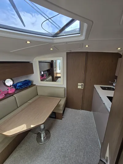 Rio Yacht Photos Pics Interior of 2019 Beneteau Gran Turismo 40 yacht with skylight, seating, and kitchenette.