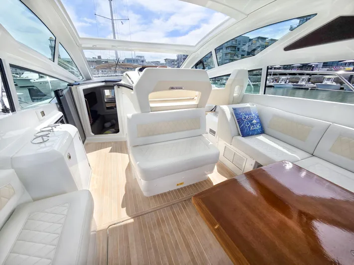 Rio Yacht Photos Pics Luxurious interior of 2019 Beneteau Gran Turismo 40 yacht with elegant seating and wooden table.