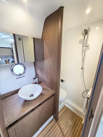 Rio Yacht Photos Pics Luxurious bathroom in 2019 Beneteau Gran Turismo 40 yacht with modern fixtures and wood accents.