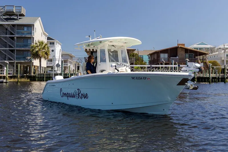 Compass Rose Yacht Photos Pics 2020 Cobia 280 Center Console boat on water near waterfront homes.