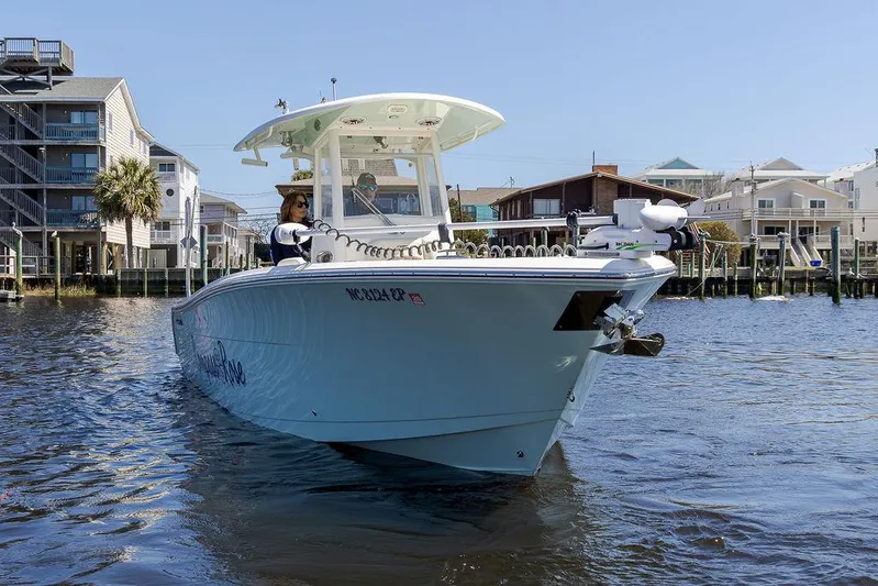 Compass Rose Yacht Photos Pics 2020 Cobia 280 Center Console boat on water near waterfront homes.