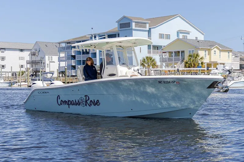 Compass Rose Yacht Photos Pics 2020 Cobia 280 Center Console boat on water near coastal homes.