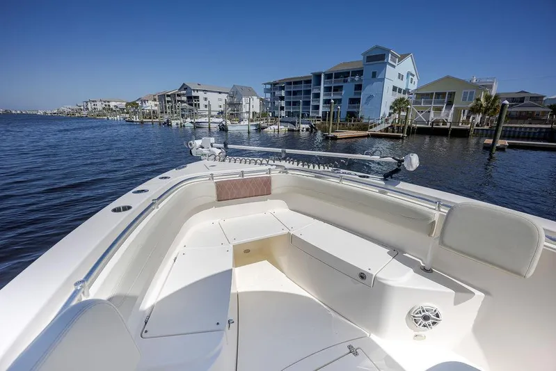 Compass Rose Yacht Photos Pics 2020 Cobia 280 Center Console boat on calm water near waterfront homes.