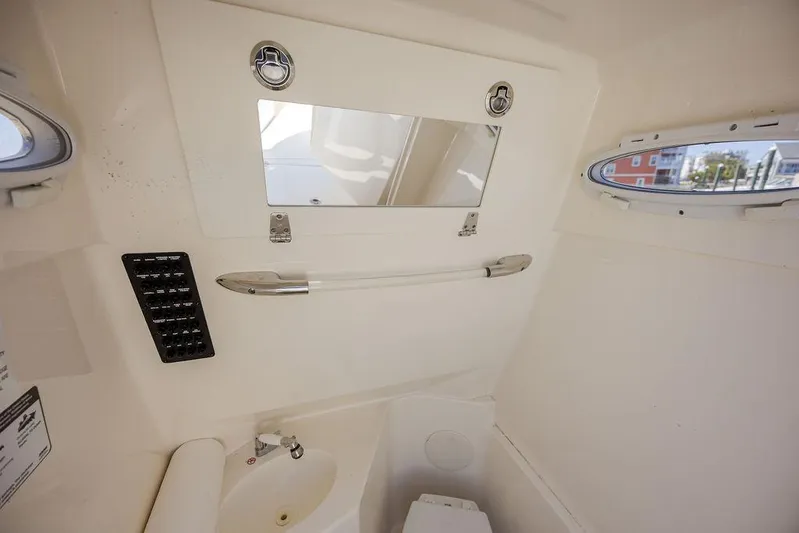 Compass Rose Yacht Photos Pics 2020 Cobia 280 Center Console interior with mirror, sink, and control panel.