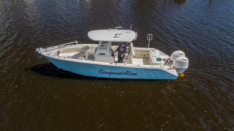 Compass Rose Yacht Photos Pics 2020 Cobia 280 Center Console boat on water, side view, with dual engines.