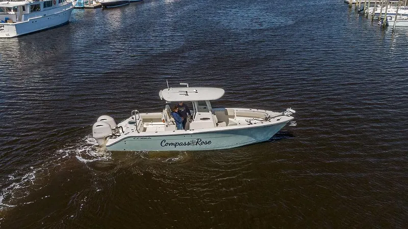 Compass Rose Yacht Photos Pics 2020 Cobia 280 Center Console boat cruising on a calm waterway.