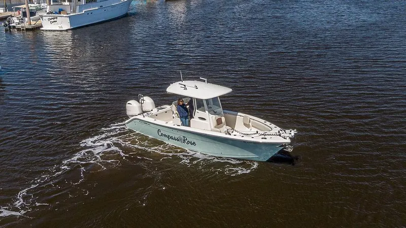 Compass Rose Yacht Photos Pics 2020 Cobia 280 Center Console boat cruising on calm water.