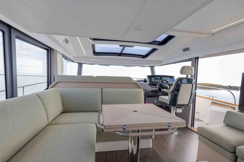 Yacht Photos Pics Luxurious interior of 2026 Nimbus 495 Flybridge yacht with modern seating and navigation area.
