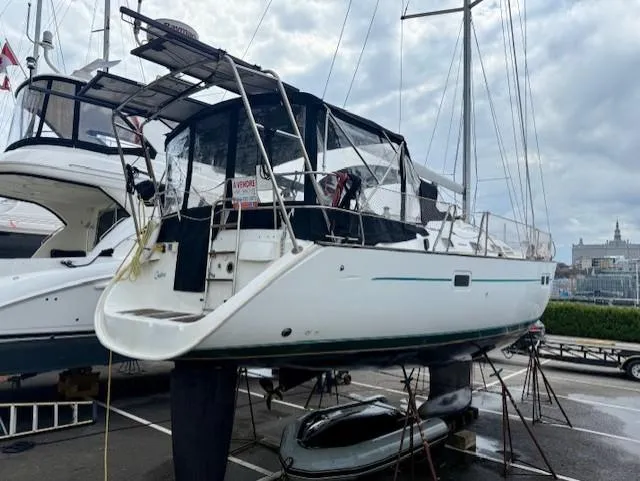 Spirit Bird Yacht Photos Pics 2004 Beneteau Oceanis 423 sailboat on stands, marina background, overcast sky.