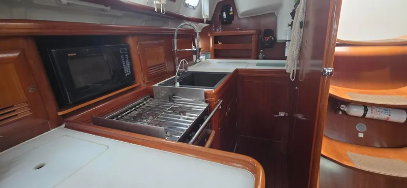 Spirit Bird Yacht Photos Pics Interior of 2004 Beneteau Oceanis 423 yacht kitchen with wood finish and modern appliances.