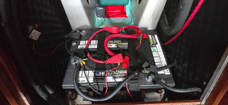 Spirit Bird Yacht Photos Pics Battery compartment of a 2004 Beneteau Oceanis 423 sailboat with connected cables.