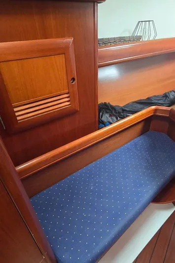 Spirit Bird Yacht Photos Pics 2004 Beneteau Oceanis 423 interior with wooden finish and blue cushioned seating.
