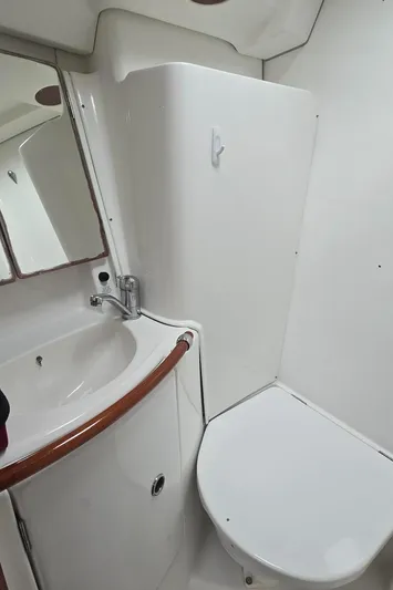 Spirit Bird Yacht Photos Pics Beneteau Oceanis 423 2004 yacht bathroom with sink, mirror, and toilet.