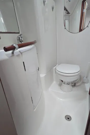 Spirit Bird Yacht Photos Pics 2004 Beneteau Oceanis 423 yacht bathroom with toilet, sink, and mirror.
