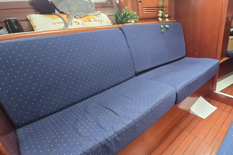 Spirit Bird Yacht Photos Pics Interior of 2004 Beneteau Oceanis 423 yacht with blue upholstered seating.