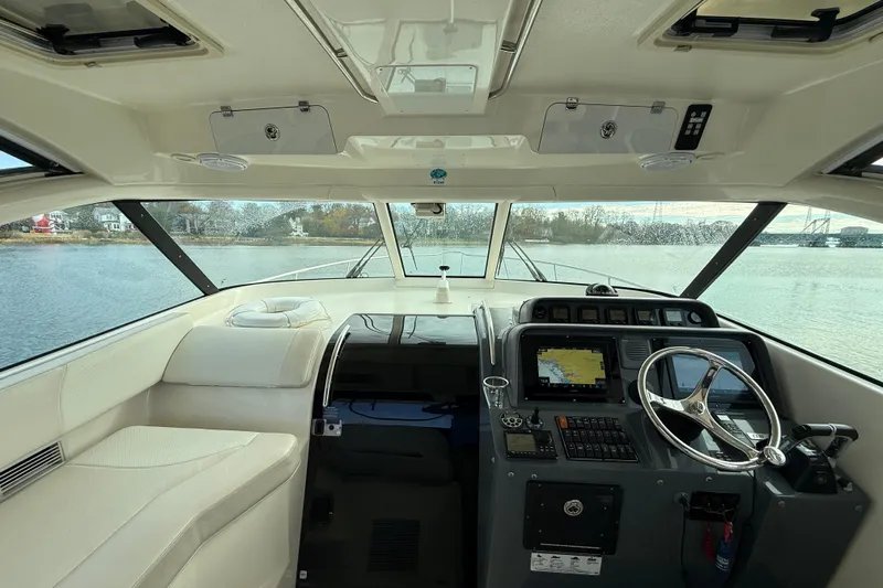  Yacht Photos Pics 2009 Pursuit OS 375 Offshore boat interior with navigation controls and panoramic water view.