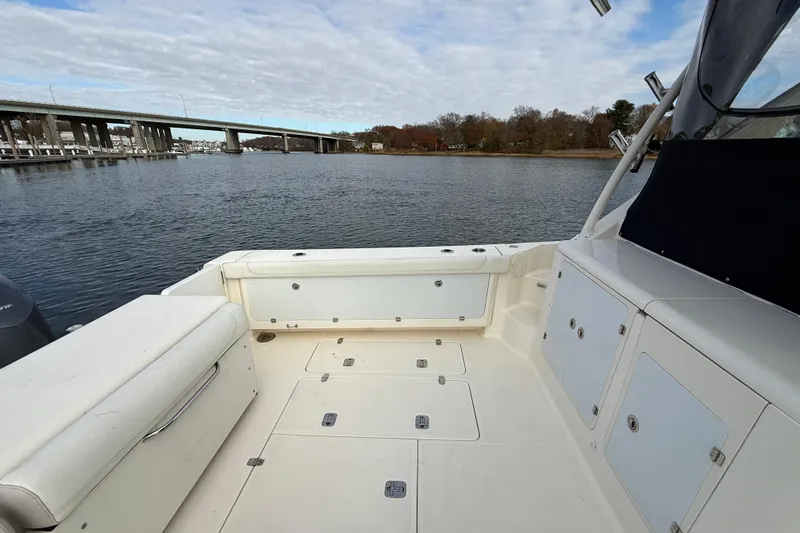  Yacht Photos Pics 2009 Pursuit OS 375 Offshore boat deck with scenic waterway and bridge view.