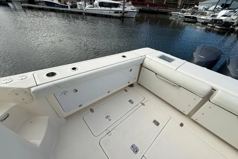  Yacht Photos Pics 2009 Pursuit OS 375 Offshore boat deck with storage compartments and cup holders.