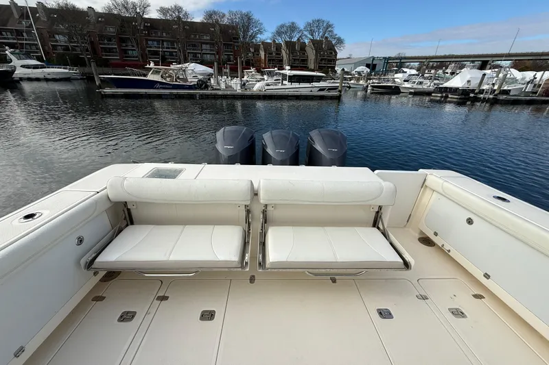  Yacht Photos Pics 2009 Pursuit OS 375 Offshore boat with dual seats and triple engines at a marina.