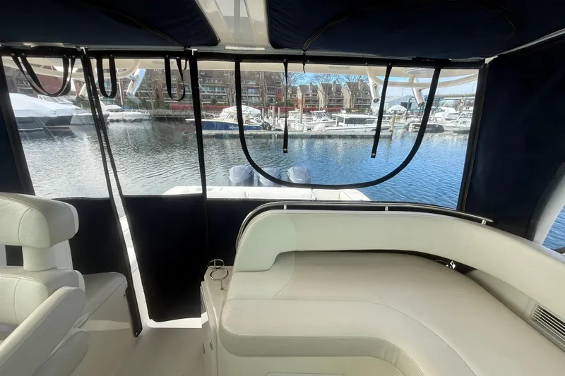  Yacht Photos Pics Interior view of 2009 Pursuit OS 375 Offshore boat with marina backdrop.