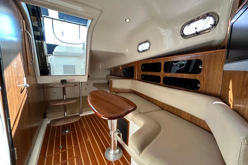  Yacht Photos Pics Luxurious interior of 2009 Pursuit OS 375 Offshore boat with elegant seating and wooden accents.