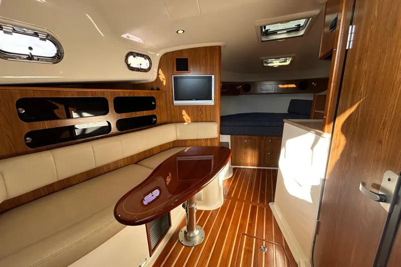  Yacht Photos Pics Luxurious interior of 2009 Pursuit OS 375 Offshore boat with wood accents and seating.