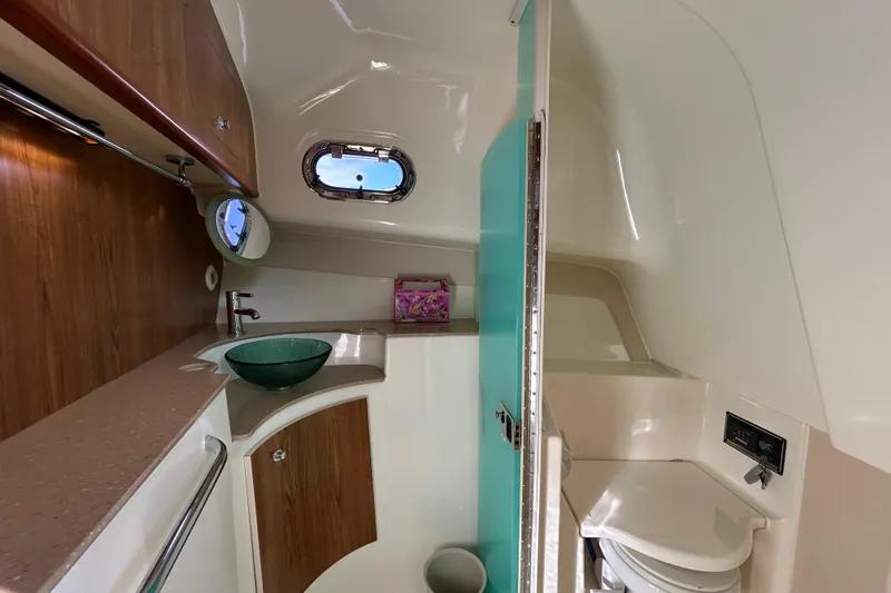  Yacht Photos Pics 2009 Pursuit OS 375 Offshore boat bathroom with modern sink and wooden cabinetry.