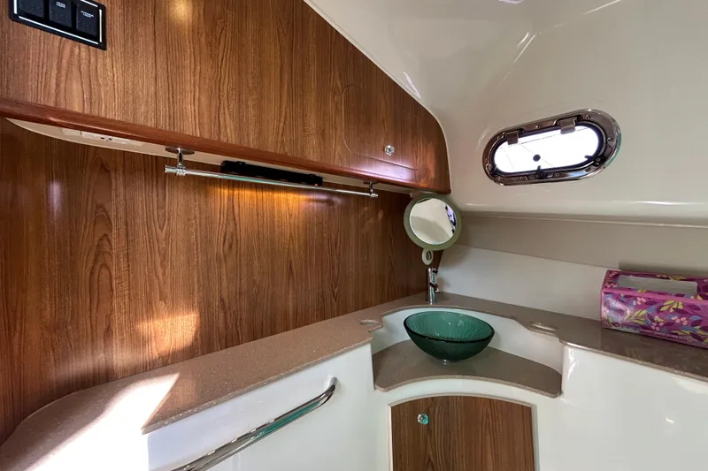  Yacht Photos Pics 2009 Pursuit OS 375 Offshore boat interior with wood paneling and modern sink.