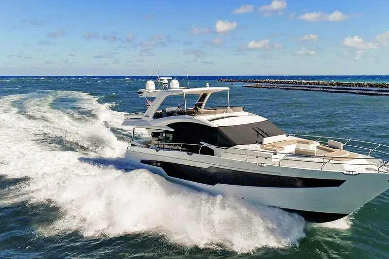 Aquasition Yacht Photos Pics 2020 Galeon 680 Fly yacht cruising on open sea under clear blue sky.